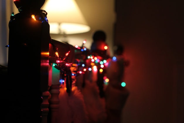 colored christmas lights on a railing.