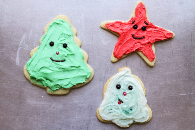 Three frosted Christmas cookies.