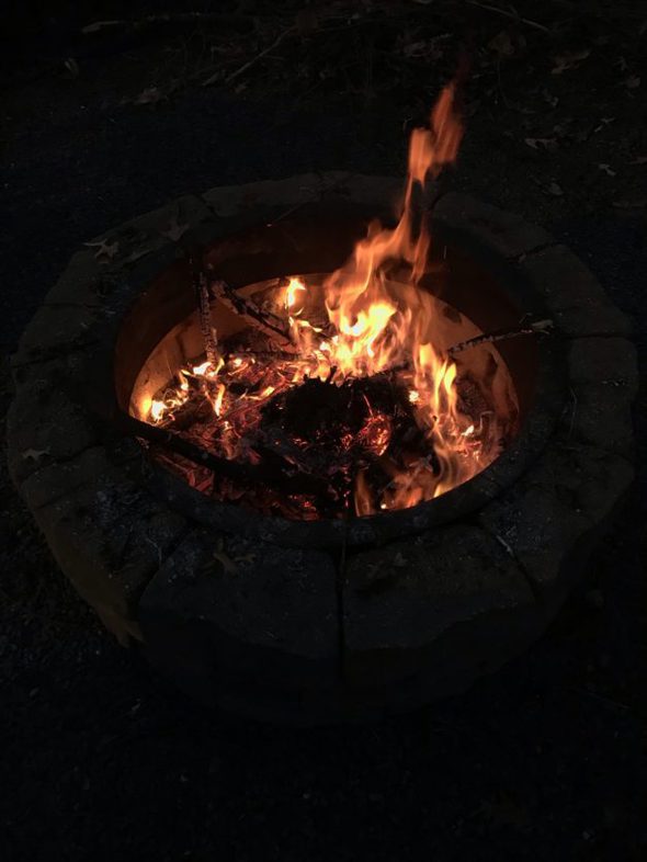 A fire in a stone fire pit.