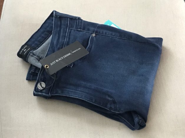 A pair of women's blue jeans, folded.