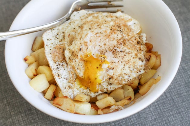A fried egg on top of chopped parsnips.