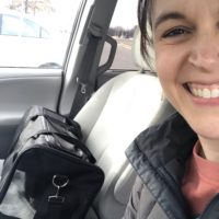 Kristen with her cat in a carrier.