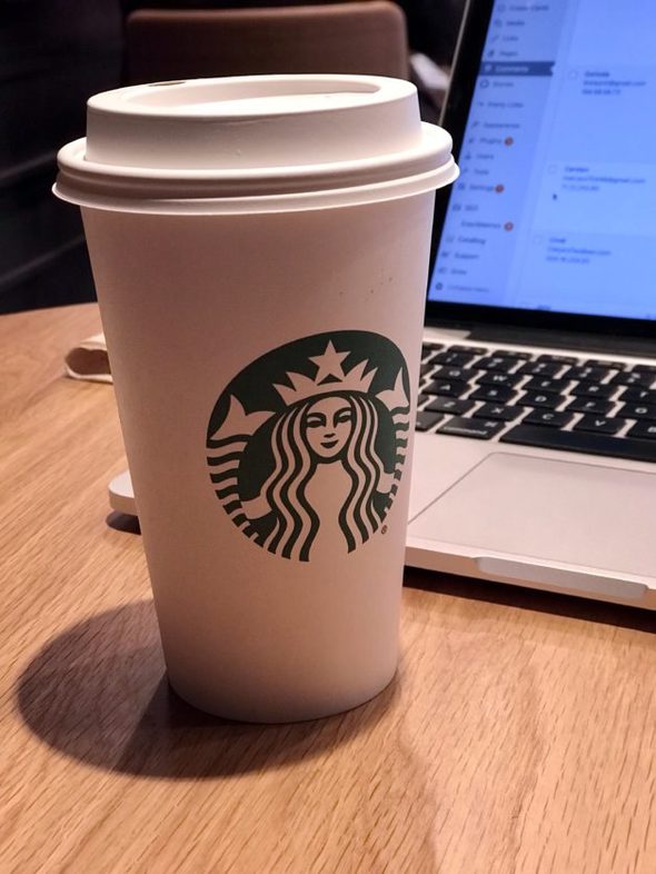 Starbucks coffee cup on table.