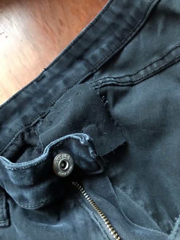 A patch inside a pair of black jeans.