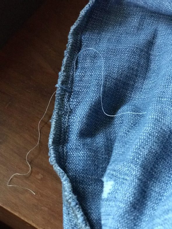 A mended blue jeans seam.