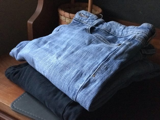two pairs of folded jeans.