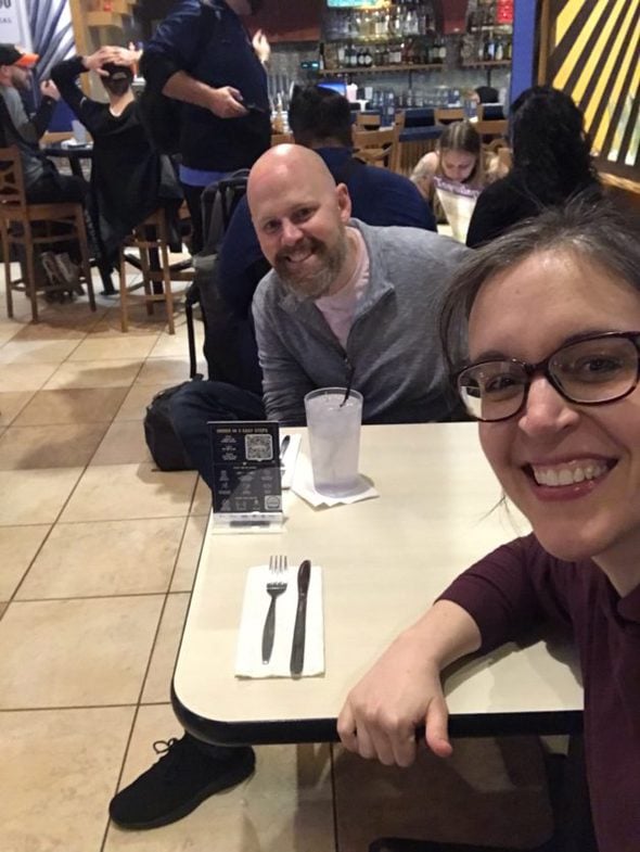 Kristen and her brother in a restaurant.