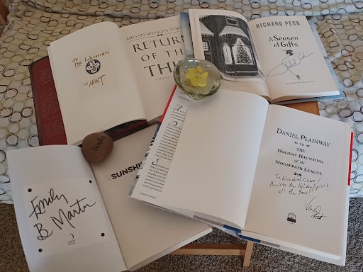 A collection of autographed books.