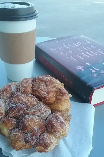 A french pastry with a coffee beside it.