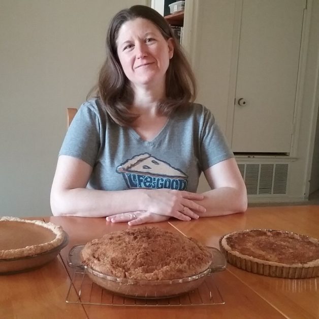 A woman with three pies.