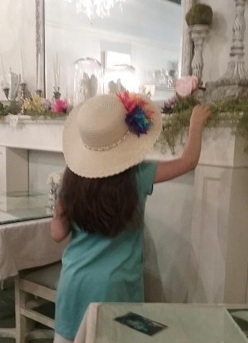 A little girl in a straw hat.