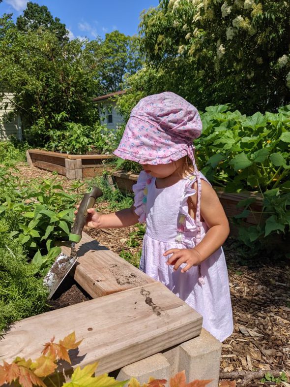 A little girl in a garden.
