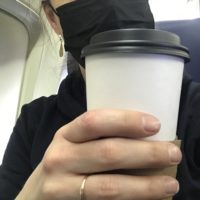 Kristen holding a coffee cup.