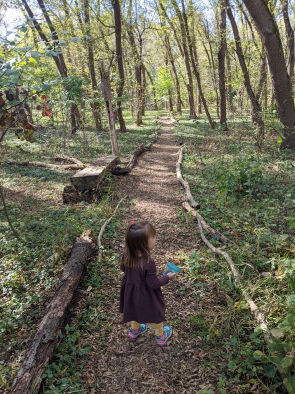 A little girl on a park path.