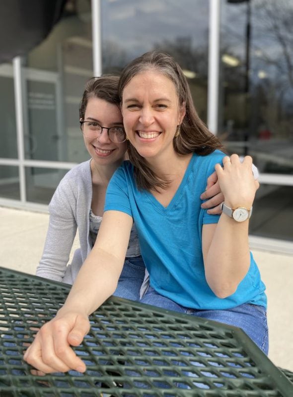 Kristen and Lisey at an outdoor table.