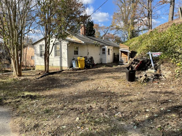 A house with a bare yard.