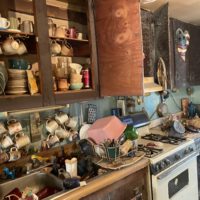 a dirty kitchen full of dishes.