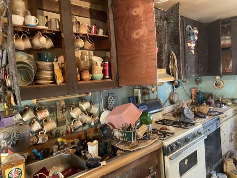 a dirty kitchen full of dishes.