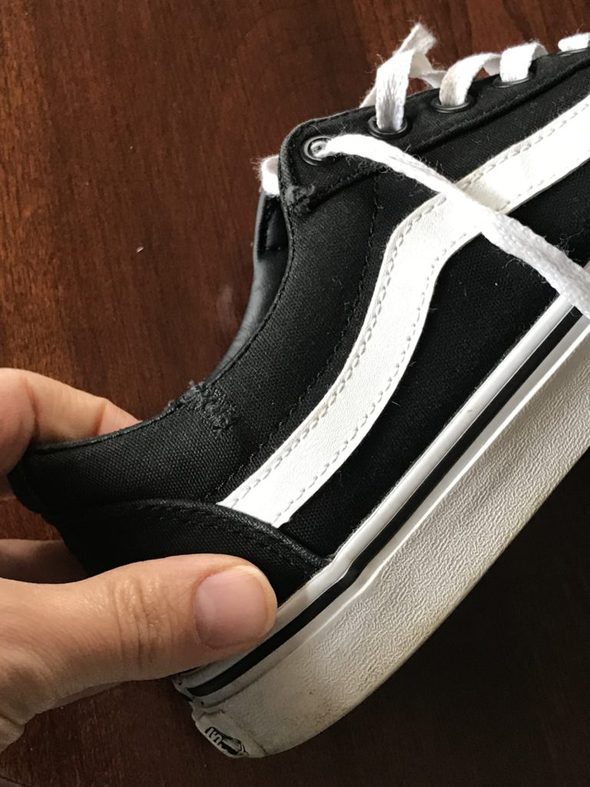 A mended black Vans shoe.