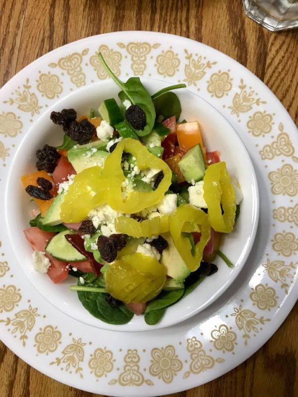 green salad in a white bowl.