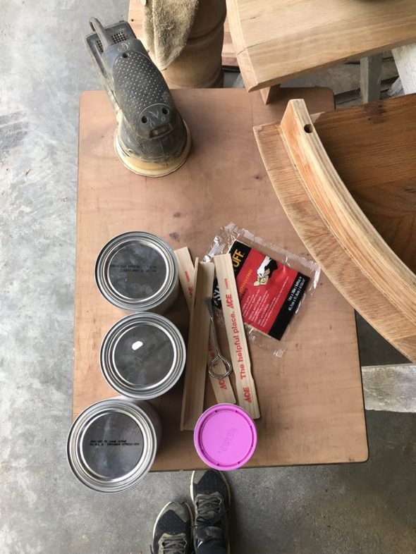 Paint cans on a wooden surface.