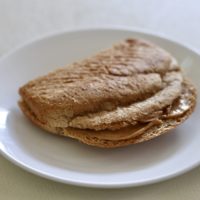 peanut butter sandwich on white plate.