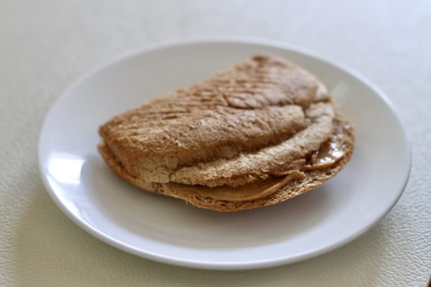 peanut butter sandwich on white plate.