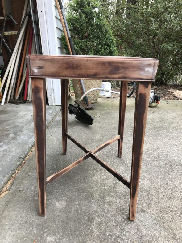 A sanded small wood table.