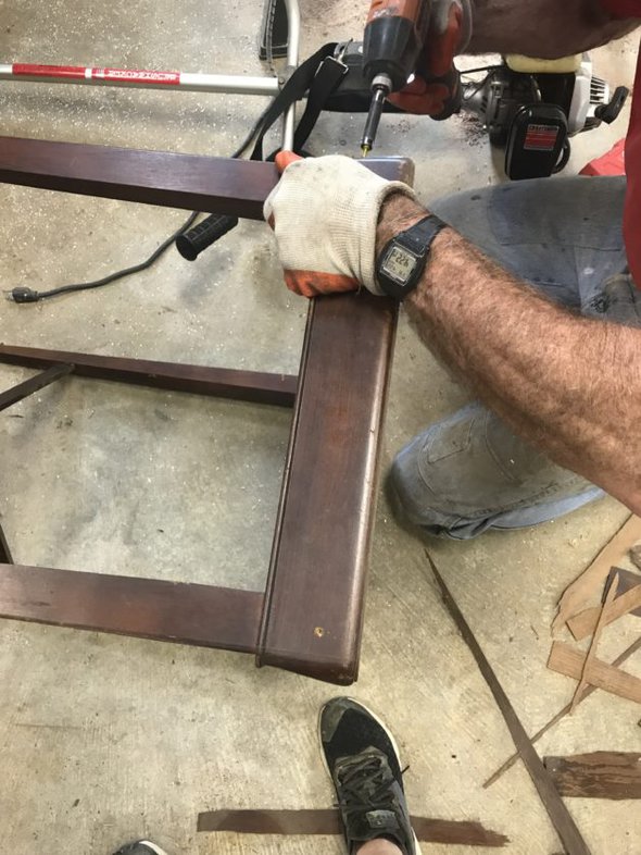 Kirsten's dad repairing a table.