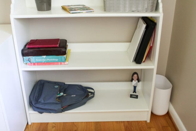 The bottom of a white bookshelf.