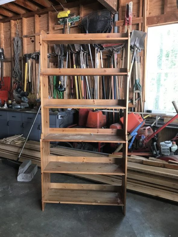 A wooden bookshelf in a garage.