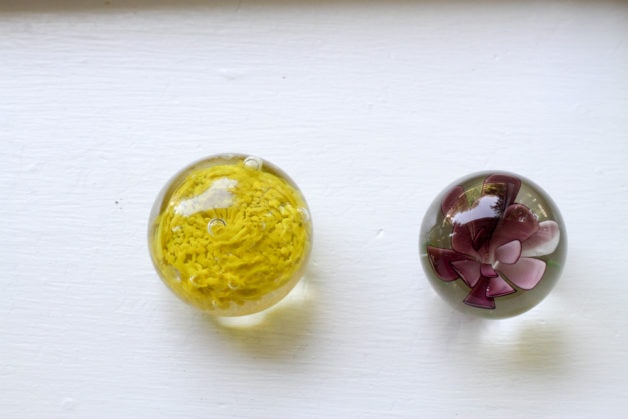 two clean glass paperweights.