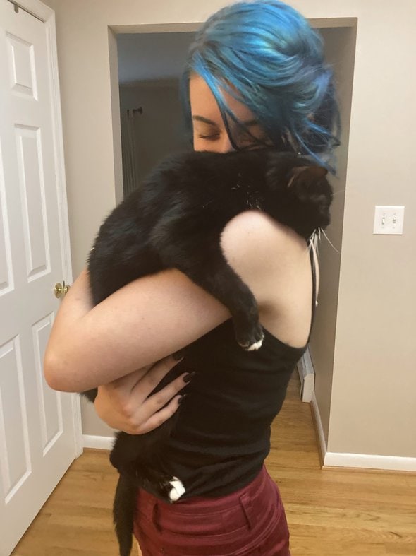 Lisey hugging the cat.