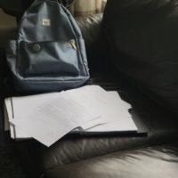 A backpack on a sofa.