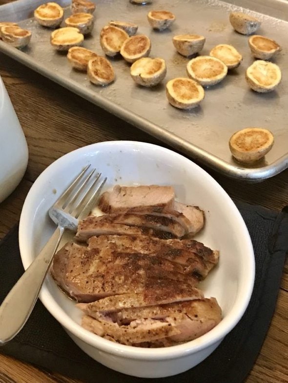 Pork and potatoes on a table.