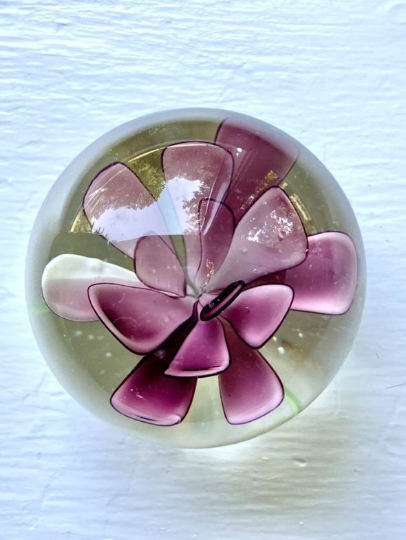 purple glass paperweight viewed from above.