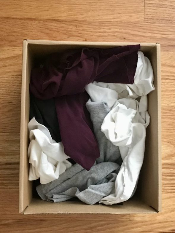 A cardboard box full of rags.