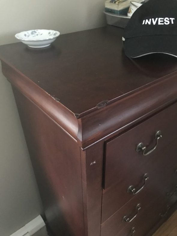 A dresser with a repaired top.