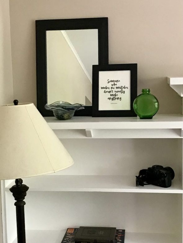 White living room shelves with a little bit of decor on them.