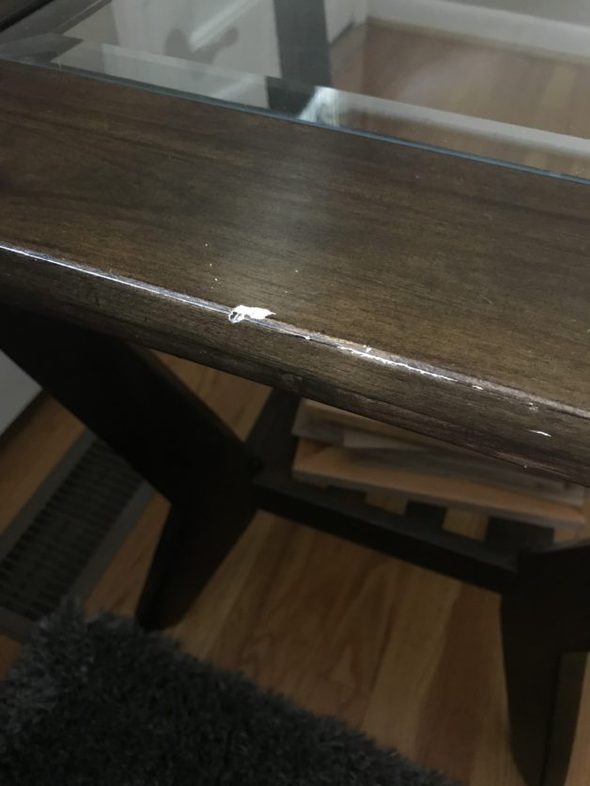A scratch on a wood end table.