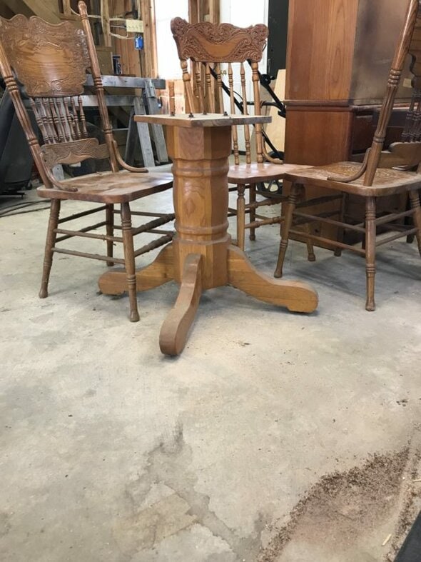 stained table base in garage.