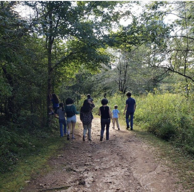 Carrie and her kids walking on a path.