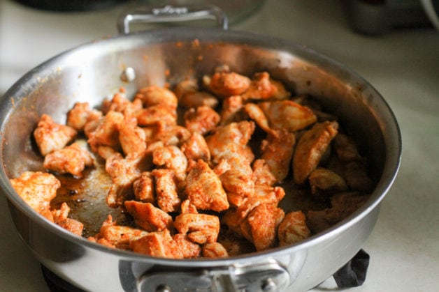 Sauteed chicken in a skillet.