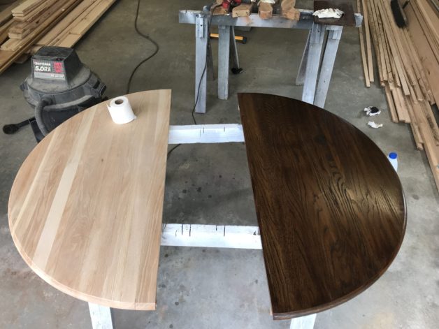 an unstained table half next to a stained half.