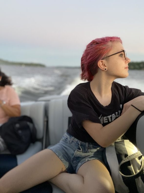 Zoe riding in a boat.