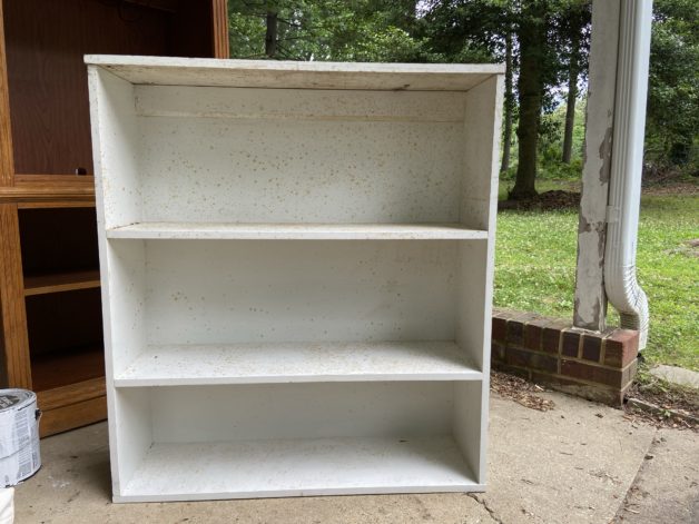 dirty white bookshelf.