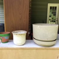 Three dirty plant pots.