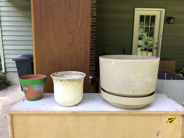 Three dirty plant pots.