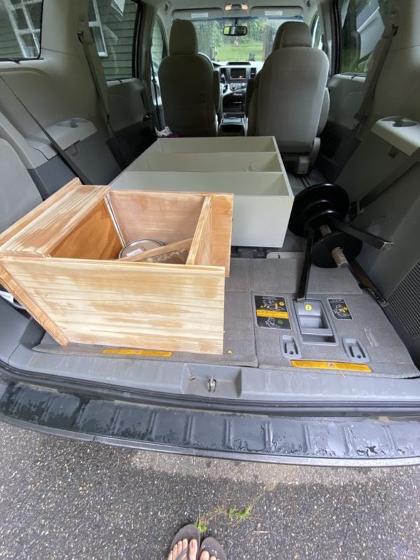 Minivan with furniture in the back.