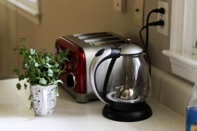 Electric kettle on countertop next to a toaster.